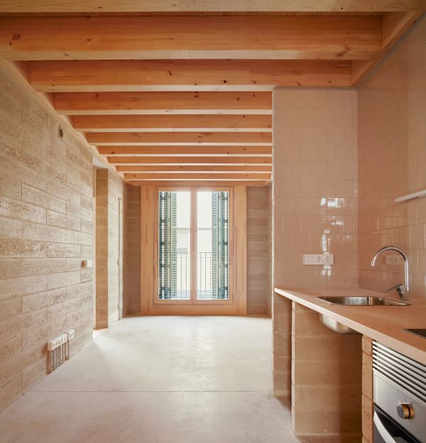Architectural project - natural materials, wood, timber, raw materials, natural light, rustic touch, sustainable design, warm tones, contemporary style, neutral tones, exposed beams, daylight, timber ceiling, beige, light wood, eco friendly, Scandinavian influence, simple design, honey wood, wood beams, timber beams, rustic modern, minimalist style, light brown, glass doors, modern rustic, Nordic design, cozy vibe, textured wall, plaster wall, stone, plaster, open layout, open plan, inviting space, green home, earthy tones, stone wall, warm vibe, stone floor, bright interior, compact kitchen, sliding doors, wood ceiling, small kitchen, interior design, renovation, modern interior, kitchen, stone texture, remodel, comfortable space, practical layout, kitchen renovation, light flooring