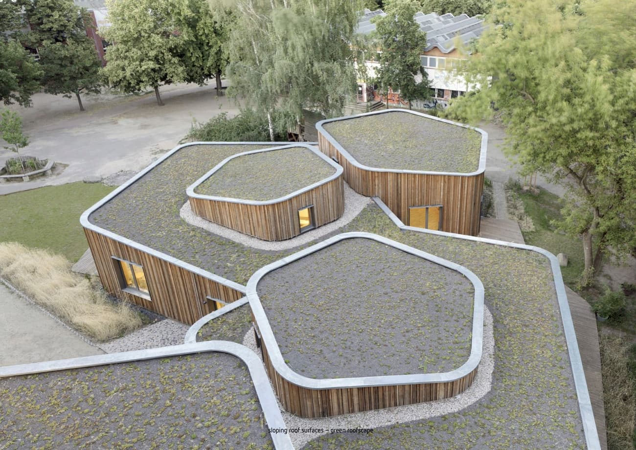 Architectural project - natural materials, wood, timber, grey, steel, metal, community space, innovative design, sustainable architecture, neutral tones, landscape architecture, brown, timber facade, eco friendly, wood exterior, natural textures, contemporary design, Scandinavian style, eco materials, modular building, eco building, green architecture, low carbon, circular design, biophilic design, wood cladding, Nordic design, modern architecture, energy efficient, earthy tones, environmental design, nature integration, passive solar, educational space, school building, public building, green roof, sedum roof, living roof, organic shapes, eco school, outdoor learning, landscape harmony, daylighting, forest integration