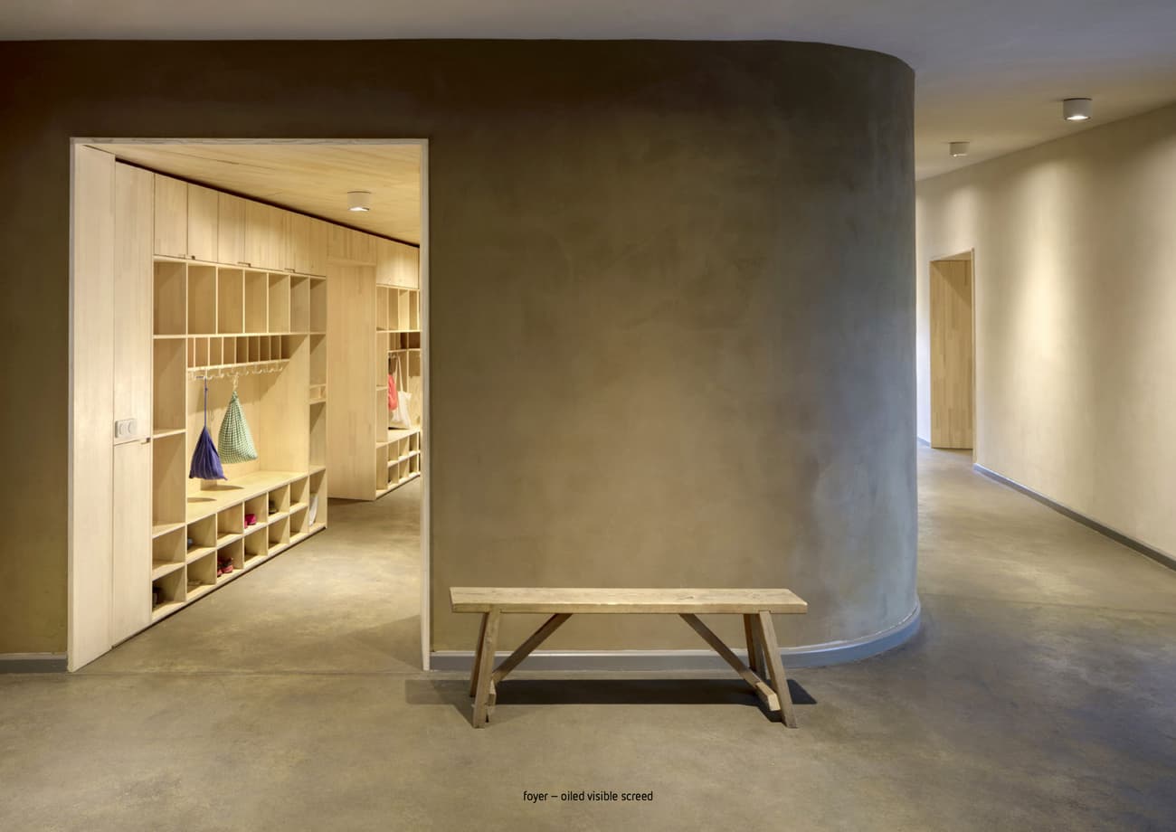 Architectural project - warm interior, indoor space, natural materials, wooden bench, soft lighting, wood, timber, relaxation area, sustainable design, warm tones, eco design, contemporary style, neutral tones, functional space, daylight, beige, concrete, natural textures, Scandinavian style, light brown, neutral palette, minimalist design, clean lines, Nordic style, plaster wall, plaster, earthy vibe, inviting space, residential design, tranquil atmosphere, beige wall, modern hallway, sleek design, interior space, home interior, foyer, corridor, hallway, minimalist hallway, wood paneling, timber paneling, curving wall, curved corridor, simple bench, built-in storage, cubby storage, storage wall, open entryway, clutter-free, streamlined, understated elegance, modern minimalist, practical design, calm setting, ground floor, brown tones