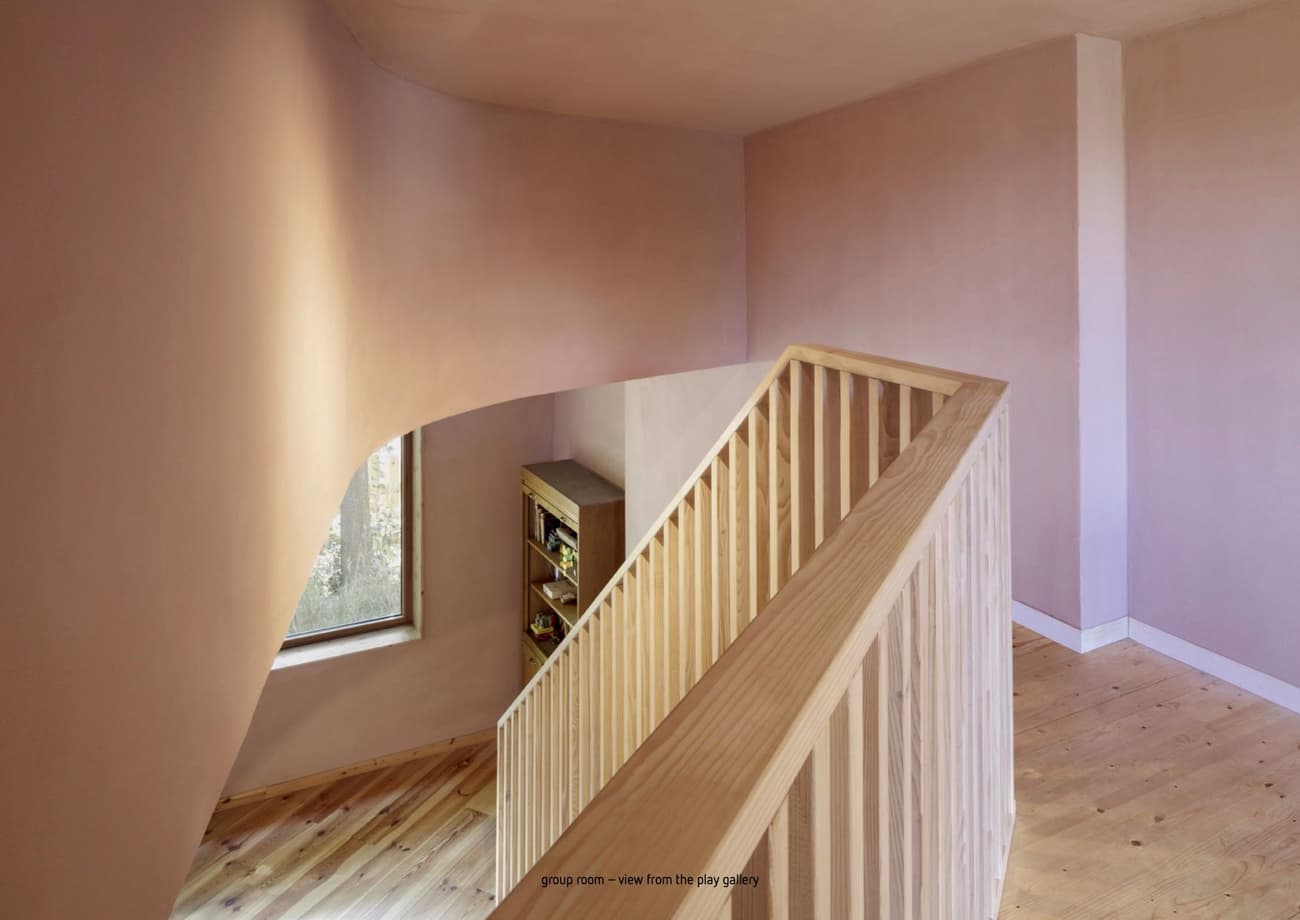 Architectural project - pastel pink, warm interior, serene vibe, architectural detail, soft lighting, pastel tones, pink, wood, timber, relaxed vibe, sustainable design, daylight, intimate corner, beige, light wood, natural wood, eco friendly, modern simplicity, contemporary interior, minimalist design, neutral colors, tranquil setting, sustainable home, light filled, Nordic style, cozy nook, comfortable home, inviting space, Scandinavian design, residential space, bright interior, modern home, home design, soft pink, curved wall, timber railing, wood flooring, minimalistic, peaceful atmosphere, open landing, staircase view, corner window, natural illumination, design detail, interior design, warm ambience, gentle hues, calm tones, airy feel, architectural elegance