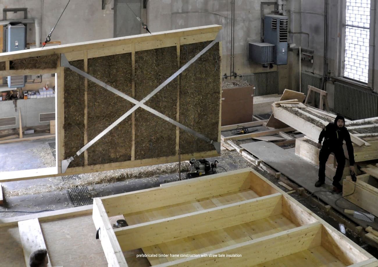Architectural project - sustainable materials, wood, timber, grey, timber frame, natural tones, modular construction, modular design, eco design, construction site, industrial vibe, construction process, beige, industrial style, minimalist construction, engineered wood, eco friendly, timber construction, sustainable building, timber elements, prefab elements, circular construction, low carbon, prefabrication, wall panel, straw insulation, assembly hall, industrial building, green materials, straw bale, natural insulation, fabrication process, structural panel, wall assembly, workshop setting, innovation in building, wood workshop, manufacturing plant, building components, construction, insulation, building technology