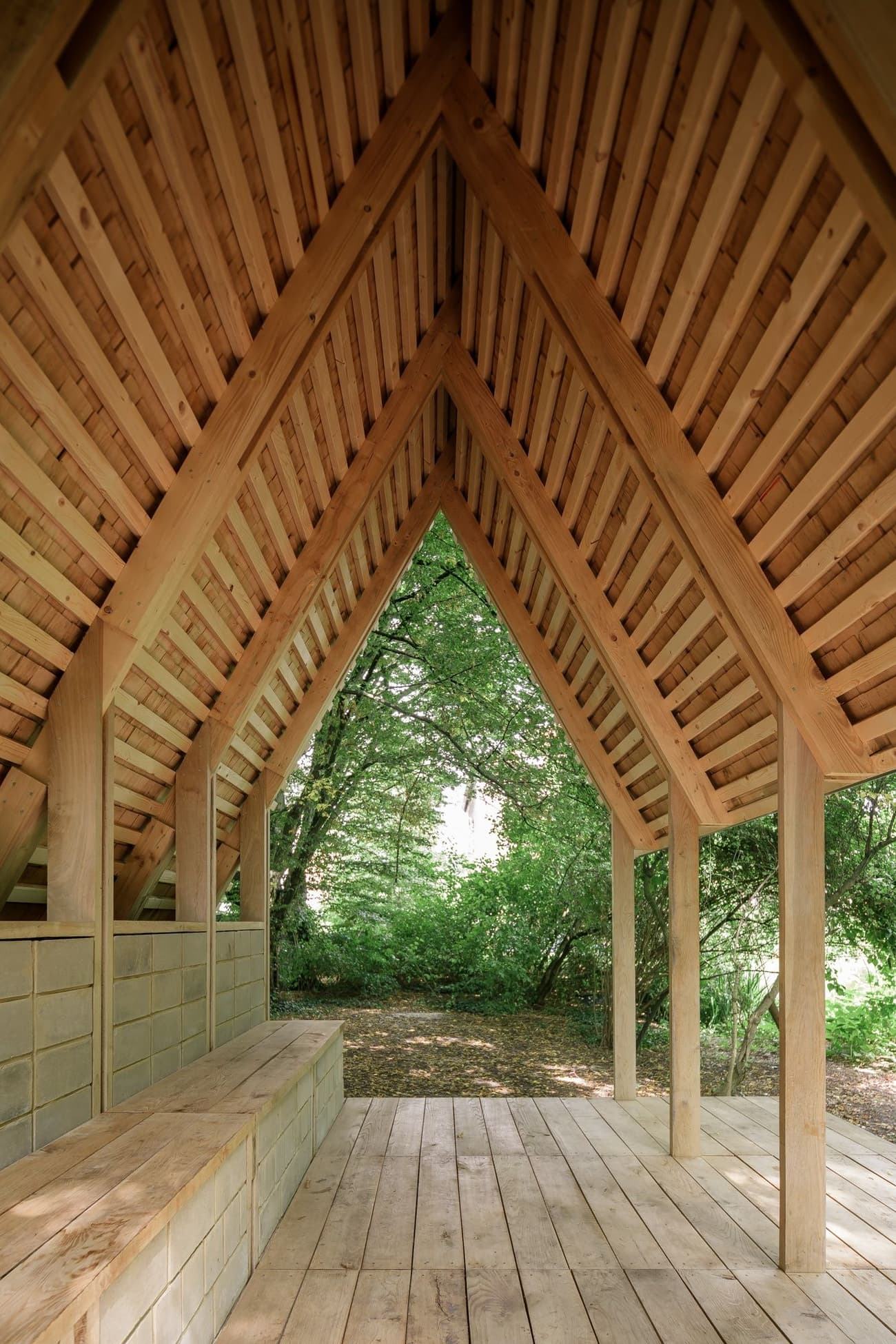 Architectural project - natural materials, sustainable materials, wood, timber, raw materials, outdoor space, timber frame, eco design, sustainable architecture, neutral tones, exposed beams, beige, brown, light wood, natural setting, wooden beams, rustic vibe, honey wood, natural textures, organic design, serene atmosphere, Scandinavian style, calming space, minimalist design, lightweight structure, light tones, wood structure, biophilic design, clean lines, timber cladding, inviting space, earthy tones, pitched roof, rustic design, shelter design, triangular roof, open pavilion, garden retreat, nature retreat, rustic architecture, slatted roof, Nordic vibe, forest view, tranquil environment, peaceful retreat, simple forms, unfinished wood, ventilated space, wooden flooring, timber flooring, eco friendly space, outdoor connection