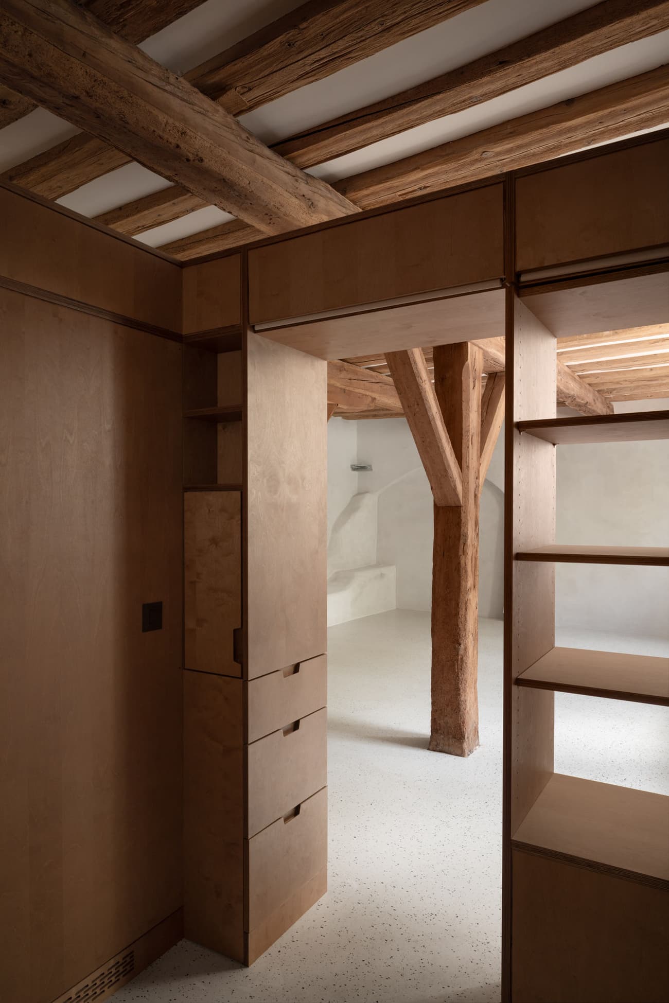 Architectural project - cozy living, Scandinavian touch, hygge, loft space, attic space, storage solution, wooden shelving, wooden drawers, timber drawers, apartment design, cozy interior, warm interior, natural materials, architectural detail, eco-friendly design, wood, timber, raw materials, warm tones, neutral tones, exposed beams, daylight, beige, brown, light wood, multifunctional space, simple design, honey wood, wood beams, timber beams, rustic modern, natural textures, contemporary design, neutral palette, minimalist design, timber panels, wood panels, structural beams, modern rustic, passive house, white, compact design, rustic style, timber interior, open plan, built-in shelves, timber shelving, residential space, nordic influence, home design, earthy textures, open space, interior design, sustainable living, modern cabin, Japandi, wood interior