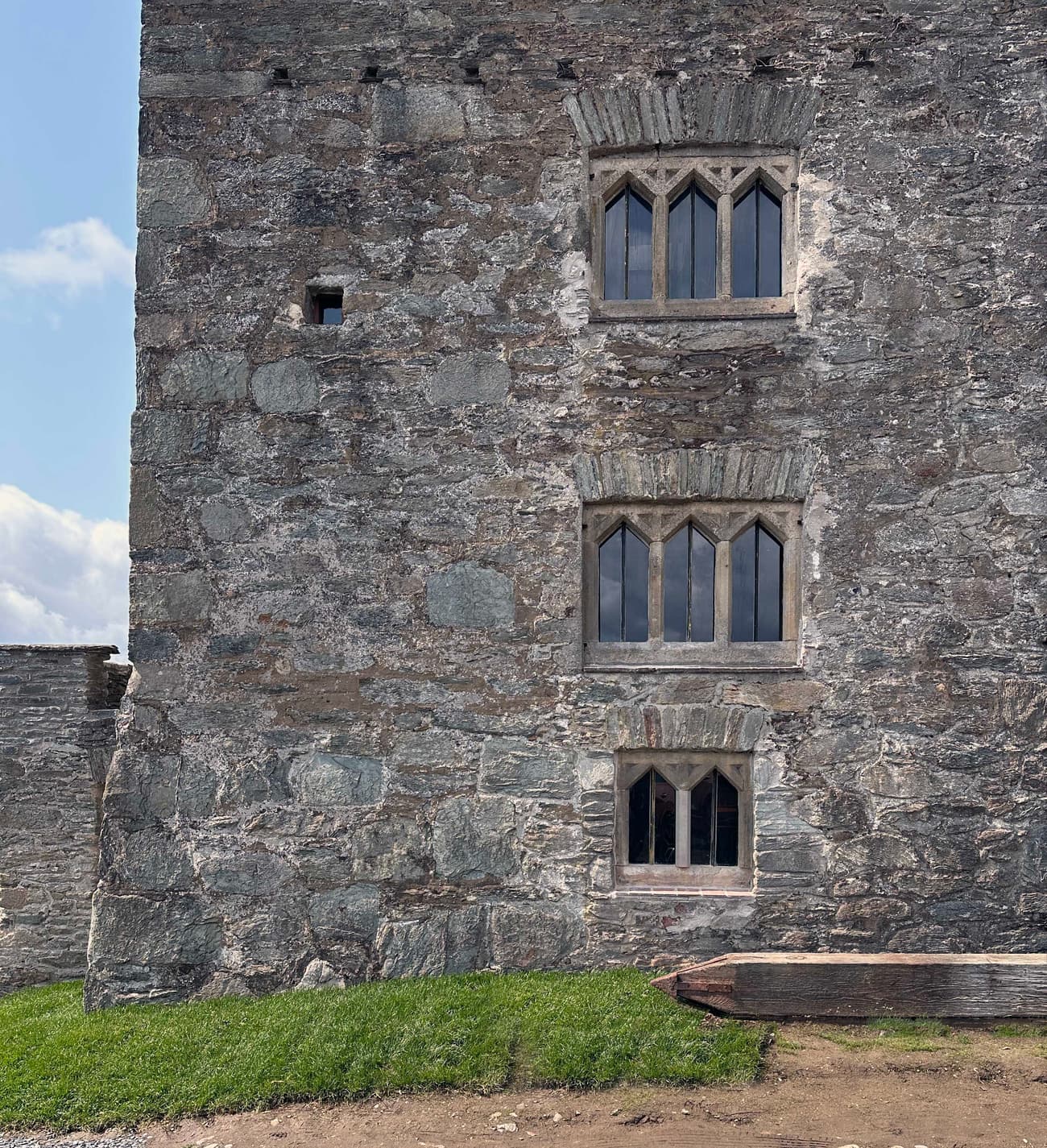 Architectural project - stone facade, exposed stone, heritage preservation, textured stone, rustic stone, stone architecture, robust structure, historic building, arched windows, historical vibe, traditional construction, masonry, old building, castle-like, architectural detail, grey, neutral tones, outdoor setting, beige, exterior wall, rustic charm, landscape view, stone, small window, rough texture, stonework, earthy tones, classic architecture, grey stone, timeless design
