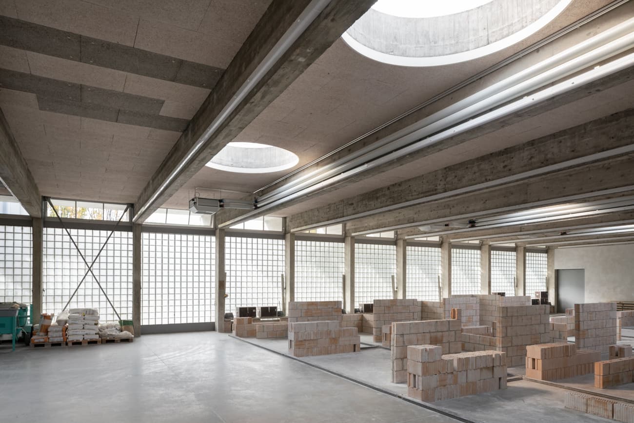 Architectural project - flexible space, light grey, warehouse style, modern industrial, workspace design, unfinished look, concrete ceiling, brick material, concrete material, brick walls, glass block walls, warehouse conversion, industrial beams, engineered beams, geometric light, renovation space, minimal design, sustainable materials, grey tones, raw materials, natural light, passive design, eco design, exposed beams, daylight, low carbon design, neutral palette, multifunctional, adaptable space, industrial chic, natural ventilation, open layout, open plan, bright interior, airy atmosphere, structural elements, contemporary vibe, industrial space, skylight, modular elements