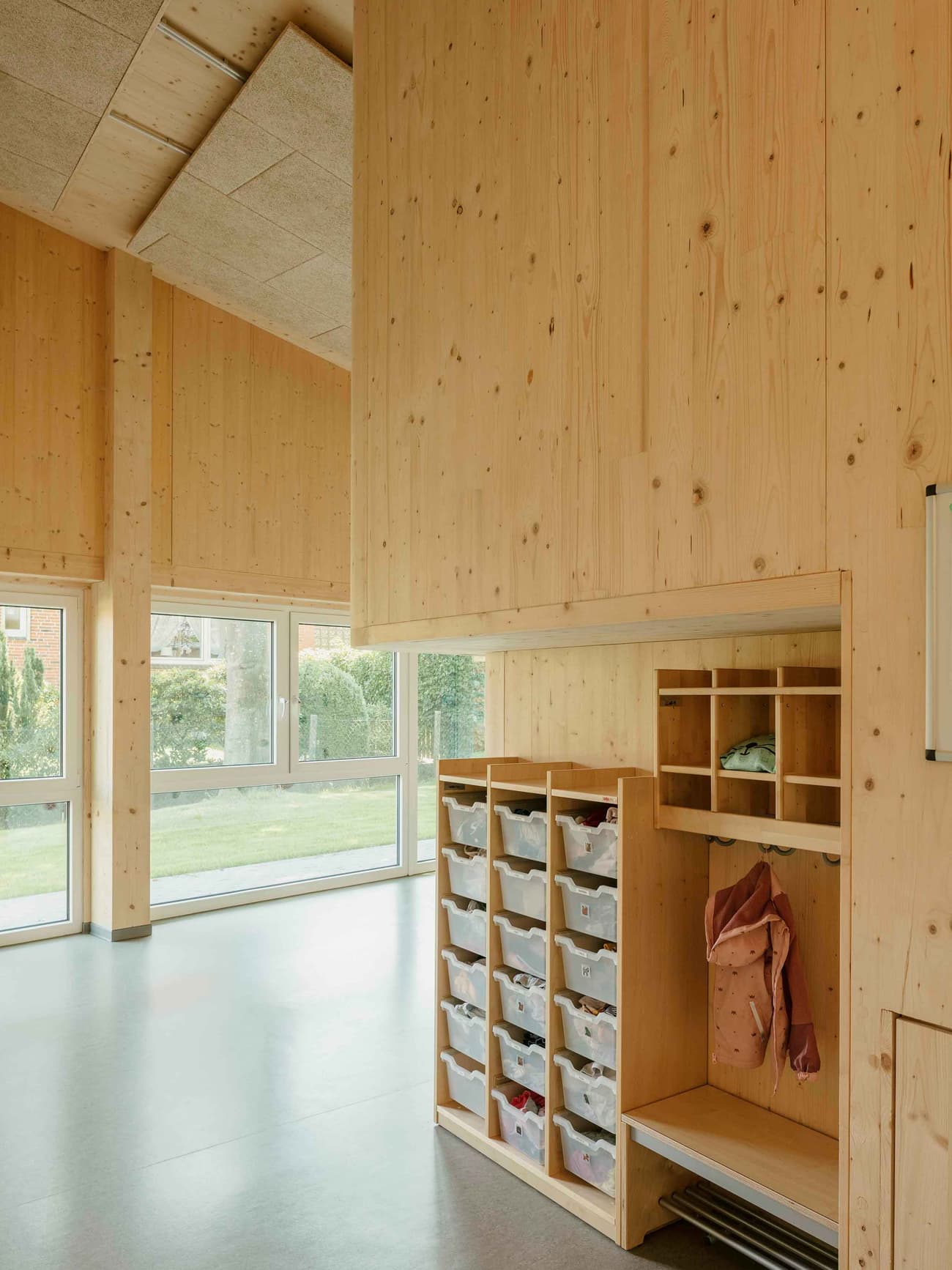 Architectural project - beige floor, calm vibe, educational facility, classroom, warm interior, sustainable materials, natural light, warm tones, eco design, neutral tones, daylight, multi-use space, plywood, light wood, natural wood, engineered wood, functional design, eco friendly, simple design, honey wood, minimalist style, community center, timber walls, passive house, large windows, timber cladding, wood cladding, Nordic design, timber interior, inviting space, child friendly, cozy atmosphere, green design, Scandinavian design, bright interior, wood ceiling, open space, educational space, learning space, modern school, indoor, built-in storage, school interior, wood interior