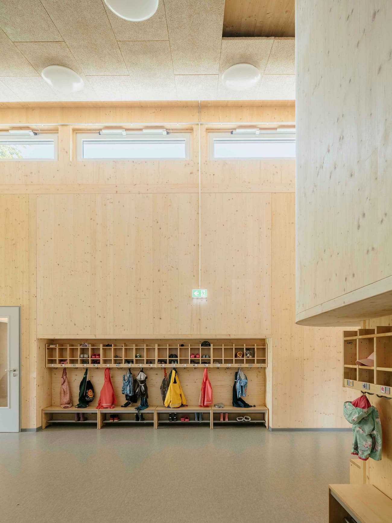 Architectural project - passive lighting, skylights, light-filled interior, educational environment, community design, simple interior, warm interior, indoor space, natural materials, eco-friendly design, wood, timber, natural light, warm tones, green building, neutral tones, daylight, plywood, beige, brown, light wood, natural wood, golden, functional design, honey wood, Scandinavian style, minimalist design, sustainable building, timber walls, exposed wood, clean lines, Nordic design, open shelves, inviting space, child friendly, cozy atmosphere, bright interior, educational space, learning space, kid friendly, modern education, contemporary school, modern school, wood storage, wooden shelves, wood finishes, wood interior