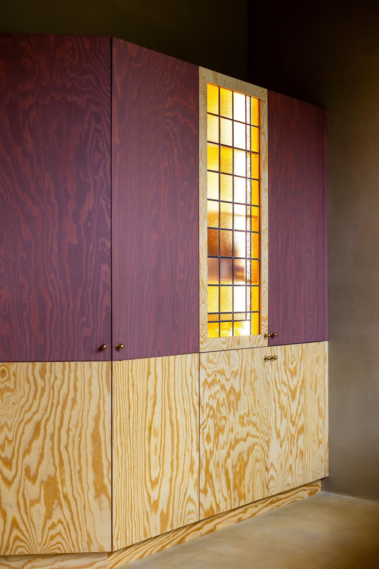 Architectural project - bespoke design, artistic vibe, colorful interior, bold design, vintage vibe, modern cabinetry, cabinetry, material contrast, amber, stained glass, colored glass, stained glass panel, purple, custom cabinets, plywood cabinetry, vibrant wood, storage design, eclectic interior, artistic detail, amber glass, purple wood, colorful contrast, mid-century influence, artistic craftsmanship, statement piece, focal point, decorative element, artistic interior, curated design, aesthetic appeal, wood, playful design, functional art, yellow, glass, warm tones, plywood, geometric pattern, yellow accents, creative space, wooden texture, wood cabinetry, visual interest, interior design, built-in storage, mixed materials, residential interior, grain pattern