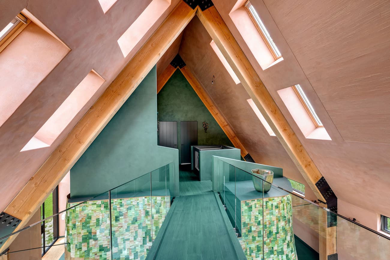 Architectural project - vibrant design, playful interior, unique home, modern loft, Scandi style, attic space, geometric forms, green tones, angled roof, loft, green interior, pastel interior, triangular shapes, textured finishes, structural aesthetics, glass railing, pastel pink, wood, timber, metal, natural light, passive design, glass, warm tones, eco design, innovative design, contemporary style, sustainable architecture, dynamic space, exposed beams, timber structure, creative architecture, light wood, modern design, wooden beams, minimalist vibe, eco-friendly materials, wood structure, light filled, plaster, open plan, cozy atmosphere, residential design, airy feel, sloped ceiling, skylight, colorful space, artistic space