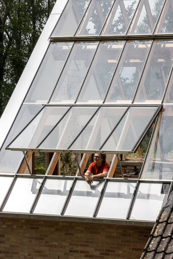 Architectural project - passive solar design, transparent roof, greenhouse effect, skylight roof, wooden supports, vented windows, garden house, atrium feel, minimalistic lines, geometric shapes, house renovation, open views, brickwork, clear, natural materials, eco-friendly design, wood, timber, natural light, glass, warm tones, eco design, green building, contemporary style, grey, timber structure, light wood, daylight optimization, glass panels, honey wood, biophilic design, indoor outdoor, white, inviting home, modern architecture, wood frame, energy efficient, sloped roof, exterior view, garden view, nature integration, bright interior, sustainable house, warm exterior, earthy textures, sustainable renovation, glass facade, architectural innovation
