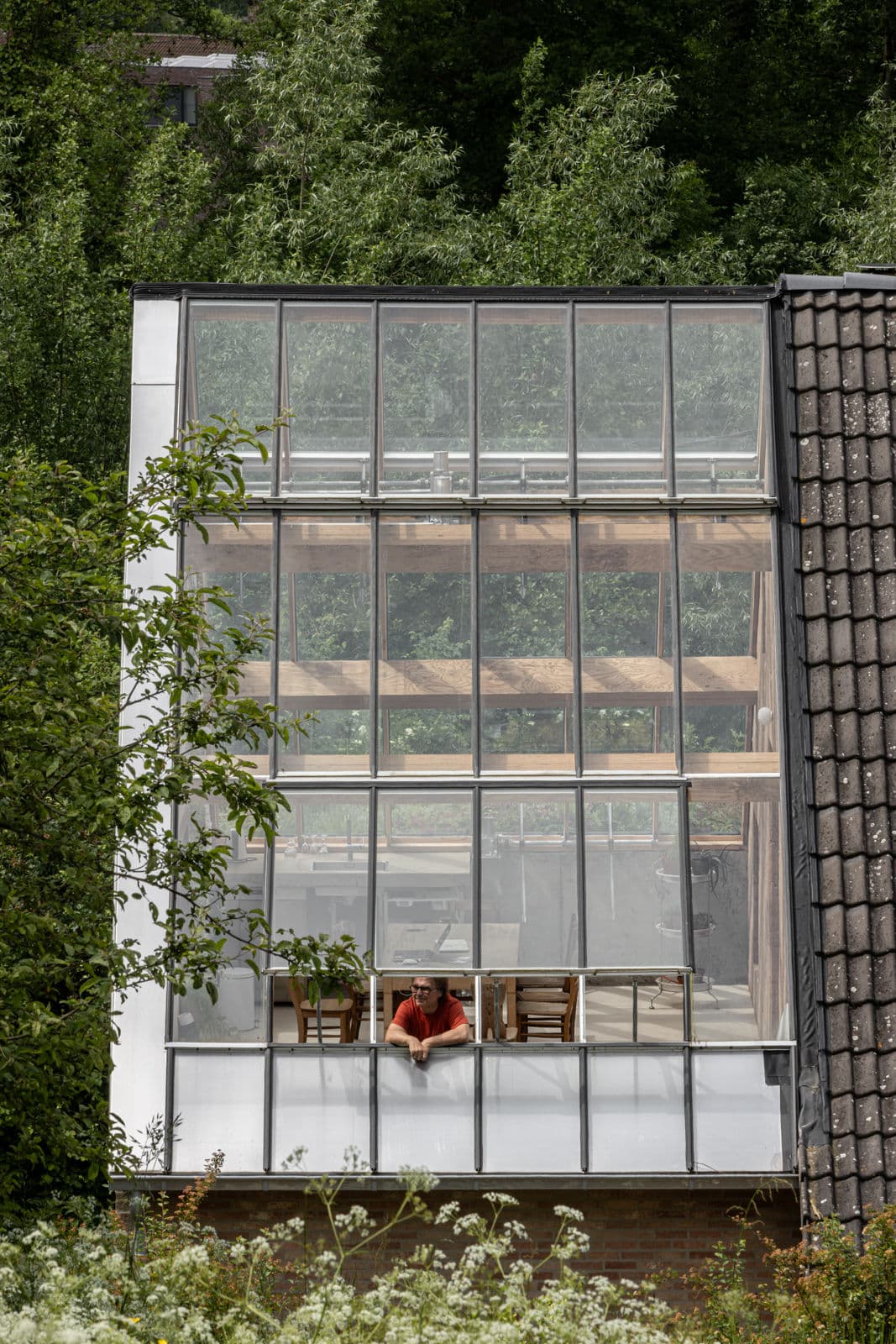 Architectural project - greenhouse effect, tiled roof, greenhouse vibe, transparent facade, plant life, open connection, clear view, architectural home, wooden details, low energy home, clay tile, cozy interior, wood, timber, timber frame, natural light, eco-conscious, glass, eco design, green, neutral tones, exposed beams, brown, eco friendly, Scandinavian influence, timber beams, rustic modern, rustic charm, timber detailing, wood structure, modern rustic, natural ventilation, light filled, indoor outdoor, energy efficient, sloped roof, rural setting, greenery, garden view, nature integration, bright interior, countryside house, sustainable house, passive solar, glass facade, sustainable living, glass wall, skylight