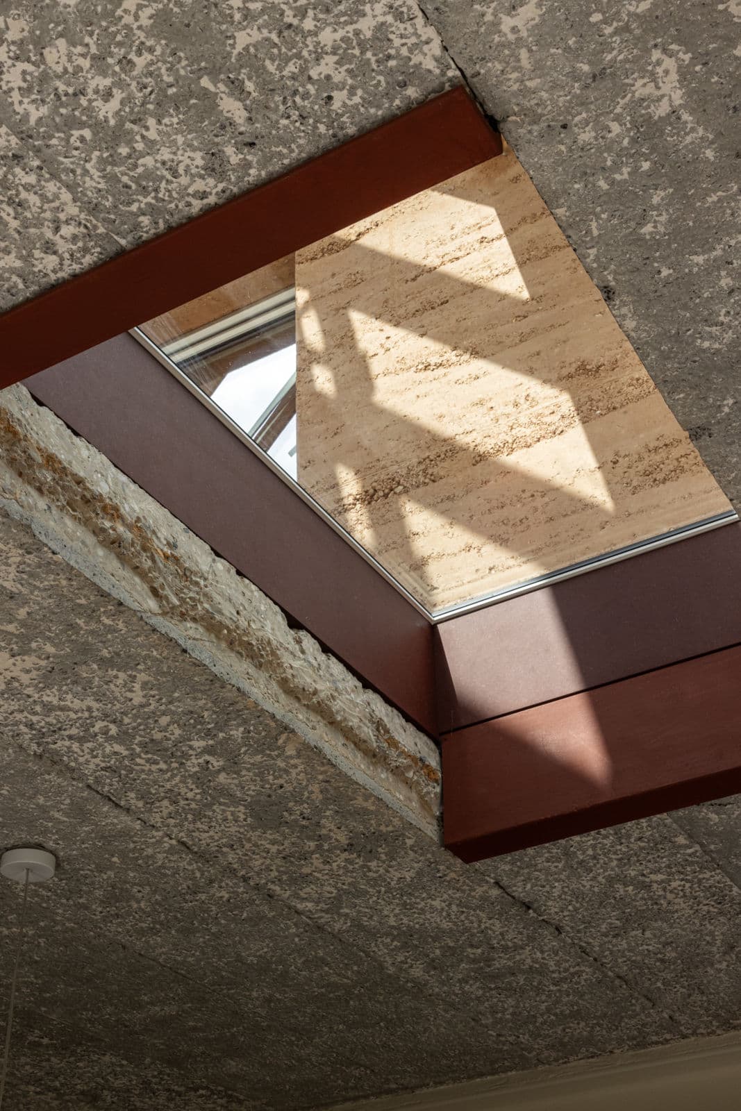 Architectural project - exposed concrete, loft style, unfinished look, textured ceiling, concrete ceiling, roof opening, ceiling detail, red beam, structural beam, indirect light, rustic feel, concrete texture, ceiling insulation, modern loft, eco interior, natural materials, architectural detail, wood, raw materials, natural light, shadow play, sustainable design, glass, warm tones, green building, exposed structure, grey, beige, concrete, industrial style, daylight optimization, eco friendly, sunlight, contemporary touch, rustic modern, minimalist design, structural detail, natural palette, rustic texture, passive house, clean lines, modern architecture, energy efficiency, skylight, red, industrial modern