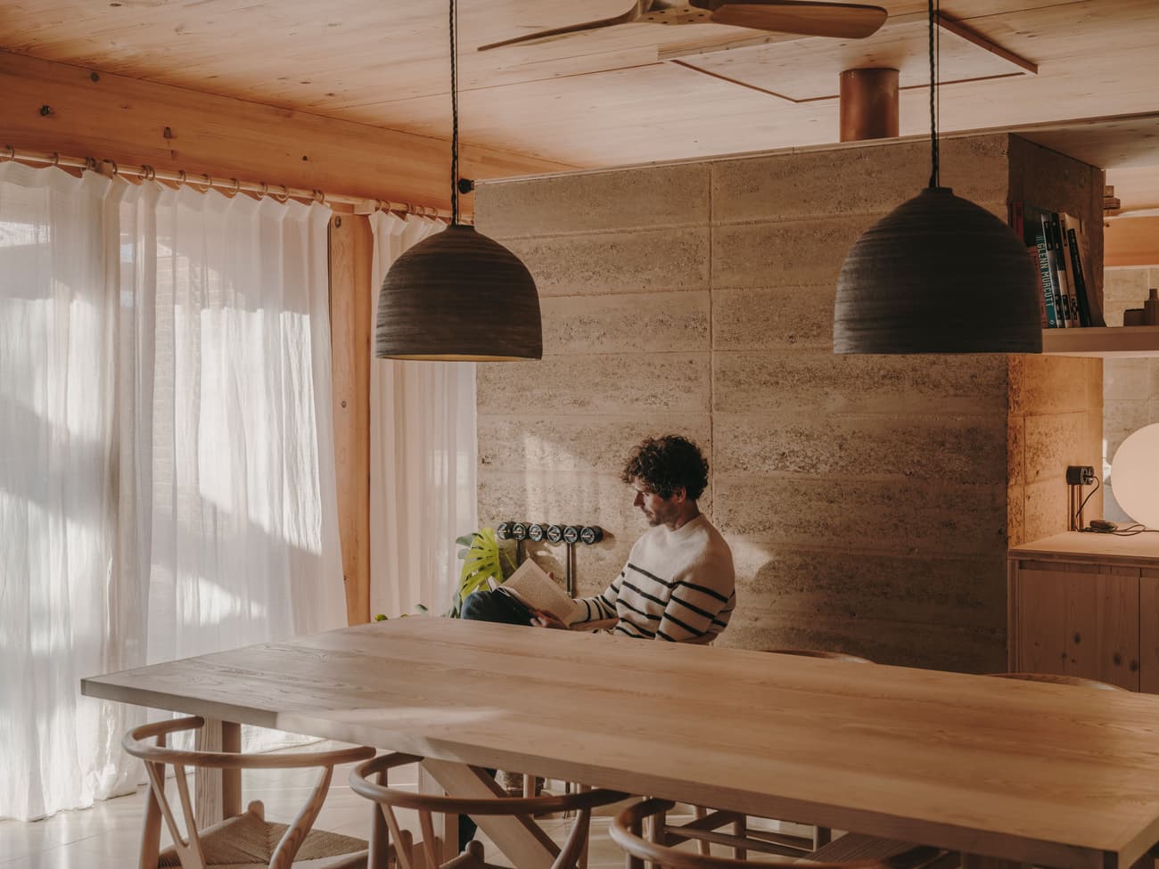 Architectural project - personal space, private corner, pendant lights, timber finishes, homey vibe, ceiling fan, warm interior, indoor space, natural materials, soft lighting, sustainable materials, wood, timber, natural light, sustainable design, warm tones, daylight, beige, light wood, eco friendly, rustic modern, intimate setting, Scandinavian style, neutral palette, minimalist design, cozy space, soft textures, rammed earth, modern rustic, inviting home, Nordic style, timber ceiling, casual living, wooden table, earthy tones, cozy corner, tranquil atmosphere, textured walls, reading nook, comfortable living, wooden furniture, relaxed ambiance, wood finishes, home retreat