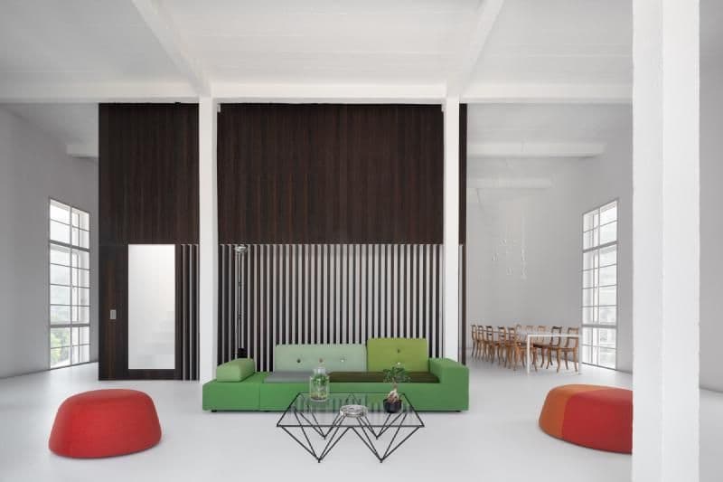 Architectural project - industrial loft, feature wall, vibrant accents, loft living, white beams, city apartment, colorful furniture, stylish home, white space, green sofa, modular sofa, wireframe table, wooden dining set, sculptural seating, pouf seating, tall windows, contrast colors, architectural beams, dark paneling, space planning, white floor, minimal design, eco-friendly design, wood, metal, natural light, glass, warm tones, green, neutral tones, daylight, industrial vibe, modern design, black, structural beams, clean lines, large windows, white, Nordic style, open plan, Scandinavian design, sleek design, bright space, simple decor, cozy home, vertical slats, geometric table, minimalist interior, contemporary living, high ceiling, urban living, red, light flooring