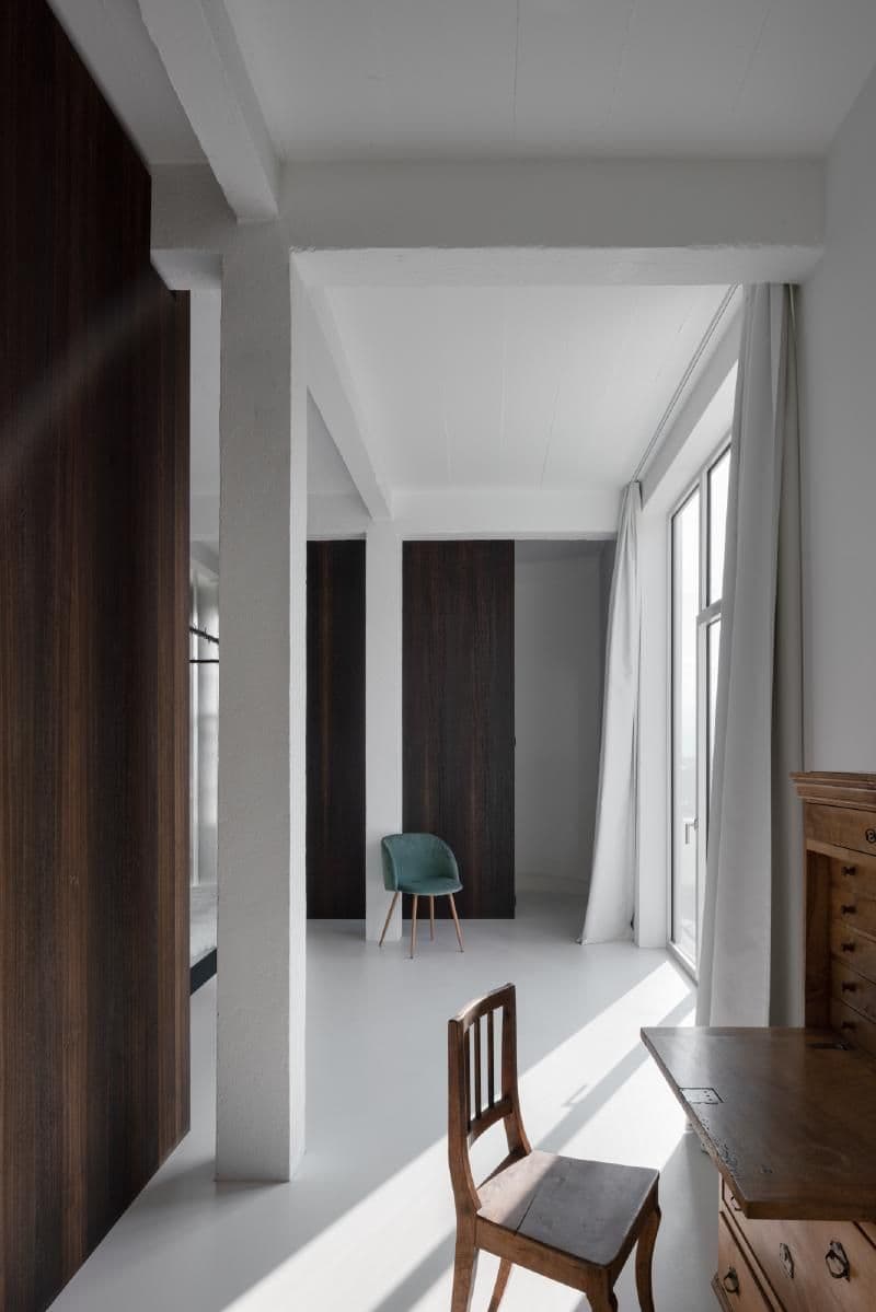Architectural project - floor to ceiling windows, peaceful environment, tranquil ambiance, modern farmhouse, wooden desk, inviting workspace, indoor setting, vintage furniture, wooden chair, modern space, dark wood panel, work retreat, teal chair, study room, streamline look, elegant interior, crisp white, soft curtains, minimal tones, sustainable materials, wood, timber, natural light, eco design, functional space, brown, simple design, contemporary design, Scandinavian style, minimalist style, neutral palette, workspace, clean lines, white walls, light filled, white, open layout, cozy atmosphere, Nordic vibe, home office, sleek design, interior, airy feel, architectural elegance, minimalist interior, home study, dark wood, high ceiling, bright room, office space