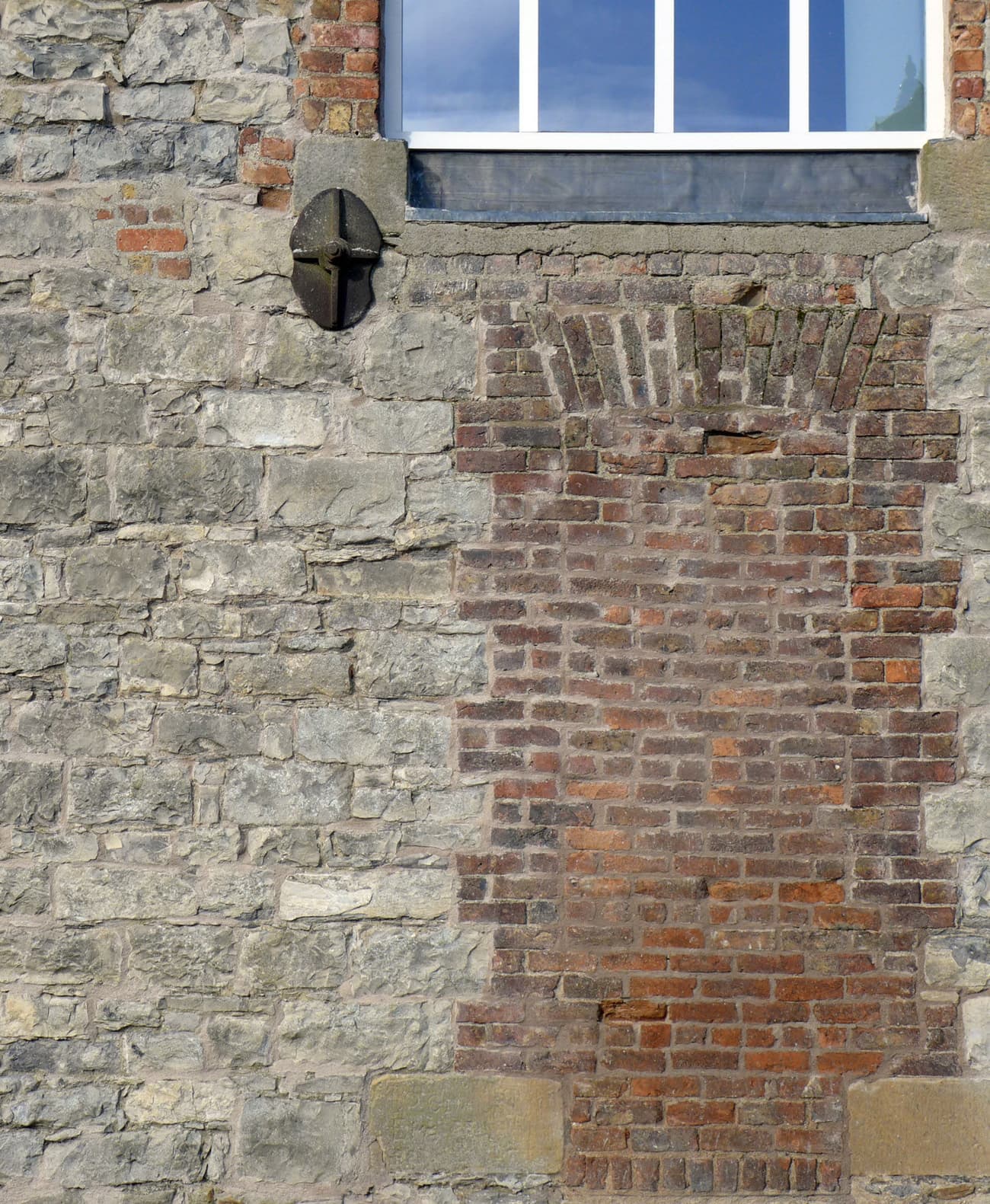 Architectural project - brick wall, heritage preservation, heritage design, rugged texture, weathered look, exposed brick, old-world charm, historic influence, masonry, classic style, European style, rustic elements, renovation design, warm tones, grey, neutral tones, beige, building facade, rustic vibe, facade detail, rustic charm, stone, traditional architecture, artisanal craftsmanship, brick, stone wall, rustic facade, rustic exterior, textured facade, window detail, architectural contrast, mixed materials, brick texture, red, stone texture