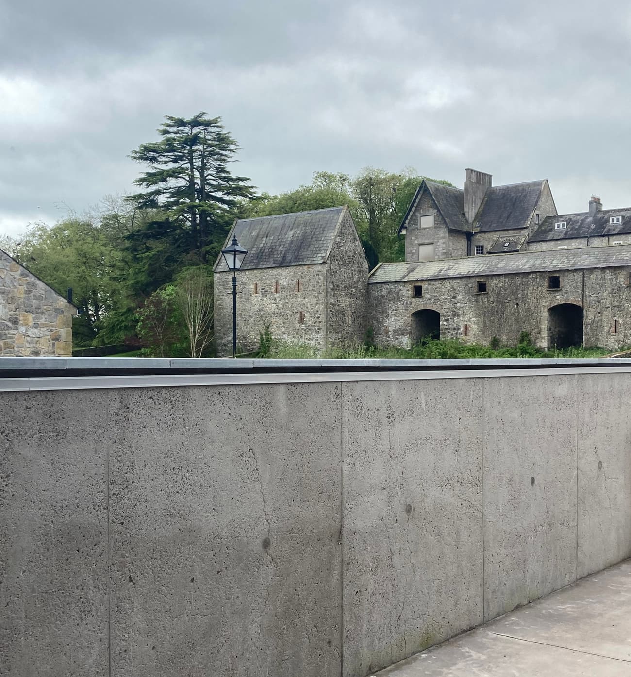 Architectural project - stone facade, scenic backdrop, architectural conservation, heritage preservation, rustic landscape, historic building, cultural heritage, heritage conservation, heritage site, stone building, European style, picturesque view, stone pavement, outdoor space, natural tones, grey, green, rural architecture, rustic charm, green landscape, stone, countryside view, stone wall, rural setting, classic architecture, exterior view, traditional style, serene setting, scenic architecture, timeless design, lush greenery, natural surroundings, stone texture