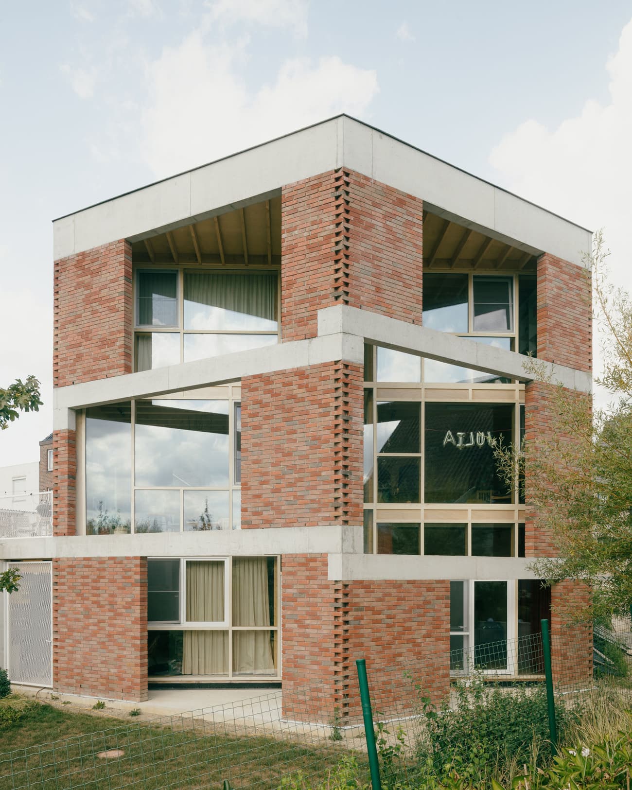 Architectural project - rhythmic pattern, urban dwelling, airy structure, brick exterior, open windows, concrete frame, grey concrete, warm brick, city home, multi-level, urban house, natural materials, natural light, passive design, sustainable design, glass, green building, exposed structure, grey, daylight, beige, concrete, low carbon design, daylight optimization, eco friendly, natural textures, contemporary design, neutral palette, minimalist design, modern facade, clean lines, modern architecture, outdoor view, energy efficient, brick, red brick, garden view, family home, residential building, glass facade, cubic shape, urban living, red